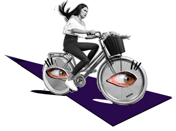 A woman riding a bike with eyes on the wheels
